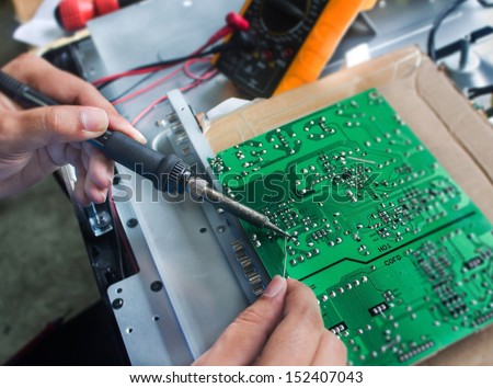 Technician repairing  a television.