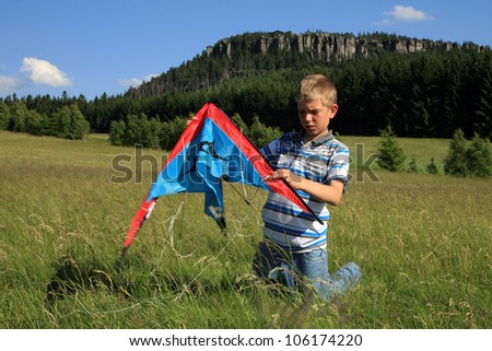 Teenage, Caucasian boy made kite on a mountain meadow - Table Mountains in Poland in village Pasterka