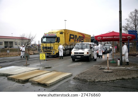 SERBIA – CIRCA MARCH 2006 : Unidentified personnel checks and disinfects vehicles at border crossing point in Serbia, circa Mach 2006. Bird’s flu is an infectious disease of birds occurs worldwide.