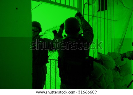 POLAND - MARCH 28: View through the night vision device during a soldiers training (battle camp) to conduct an attack inside a building at night March 28, 2008 in Poland.