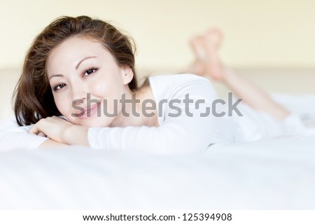 Attractive Asian Mixed Woman in Bed Smilling