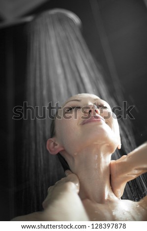 Attractive mixed asian woman washing neck in shower