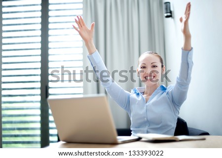 Attractive Asian Business Woman with hands raised