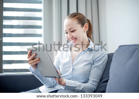 Attractive Asian Business Woman on the sofa with a tablet