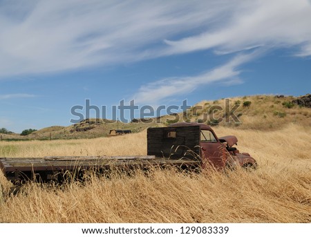 An abandoned truck in the rural field