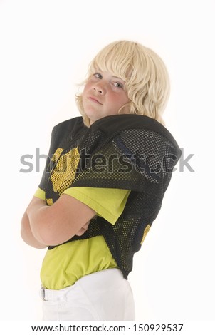 boy in American football uniform folding arms