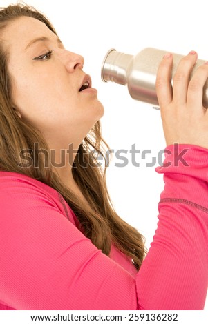 Female model drinking from stainless steel bottle