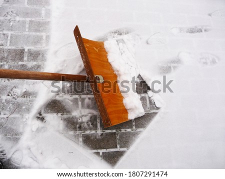 Image, Stock Photo Shoving snow on the roof. Remove snow from solar system