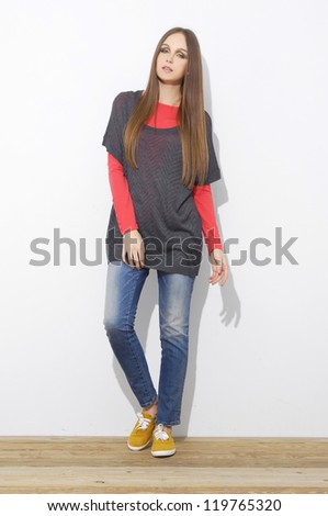 full length Slim pretty young girl isolated on wooden floor posing