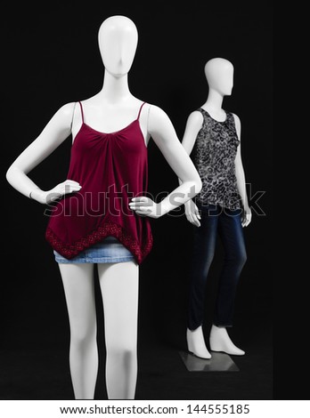 two mannequin dressed in red blouse with shirt on black background
