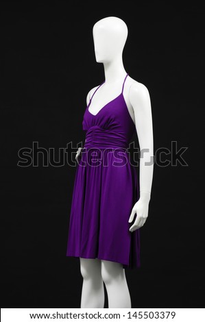 Mannequin dressed in red dress on black background
