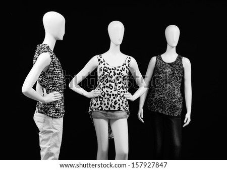 Three mannequin dressed in fashion shirt and trousers in black and white