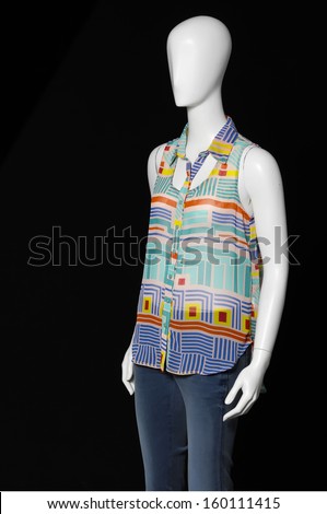 mannequin dressed in shirt and jeans on black background