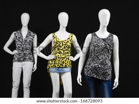 Three mannequin female fashion dress with jeans on black background
