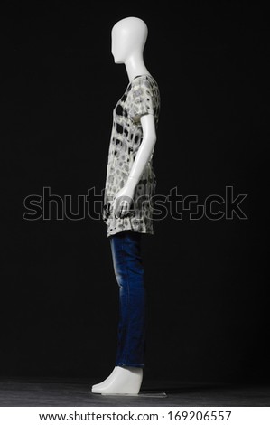 side view mannequin female dressed in fashion shirt and jeans on black background