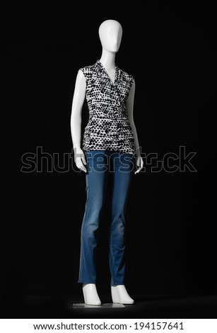 full-length mannequin female dressed in shirt and jeans on black background