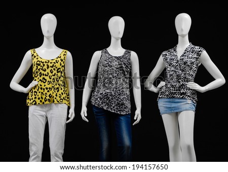 Three mannequin dressed in fashion shirt and trousers ,jeans on black background
