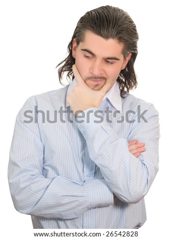 Young worried dark haired businessman in light blue striped shirt holds hand on his chin isolated on white