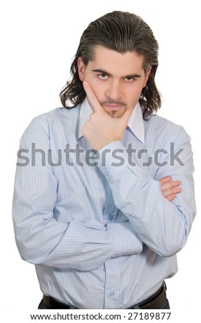 Young worried dark haired businessman in light blue striped shirt holds hand on his chin isolated on white