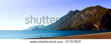 Panoramic shot of a sea coast in South Turkey with hills and rocky mountains in the background
