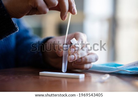 Similar – Image, Stock Photo Covid 19 antigen self test for nasal swab with positive result. Antigen test kit for home use to detection coronavirus infection. Negative test result from rapid antigen test. Coronavirus diagnosis.