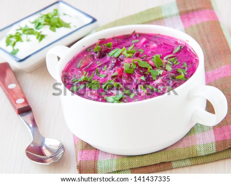 Traditional cold Lithuanian summery soup made of beets, cucumbers, egg and herbs in white plate