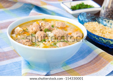 Delicious and healthy hot soup with barley bulgur and small meat balls, warming food