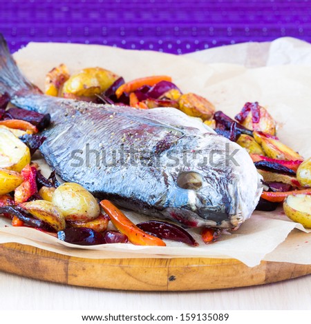 Baked whole fish dorada with grilled stew of roots