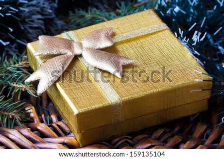 Gift in gold box under tree for Christmas