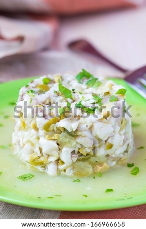 Tartar ceviche of raw white fish with olives, lemon, sauce, capers, onions, parsley, gourmet appetizer