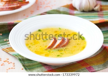Cream soup of red lentil with smoked meat, duck, chicken, garlic, dietary oriental dish with spices