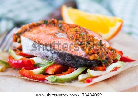 Steak red fish salmon on vegetables, zucchini and paprika with salsa, tasty diet dinner