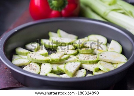 Fresh sliced zucchini with herb in form for baking, cooking spring, summer delicious dish