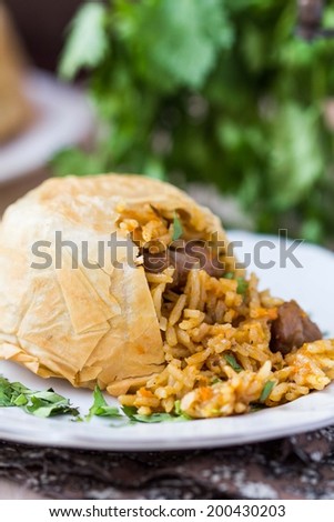 Oriental shah pilaf, pilaw, plov, rice with meat in pastry filo, delicious fragrant spicy dish