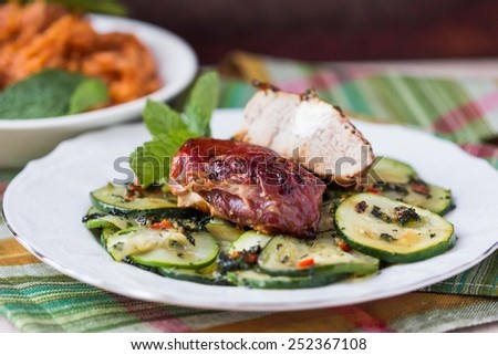 Pork steak, meat stuffed with feta cheese with bacon pancetta and zucchini salad