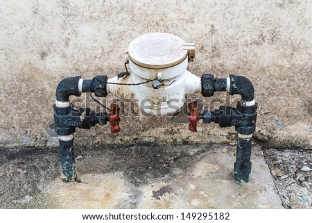 Old dirty water meter and rusting valve