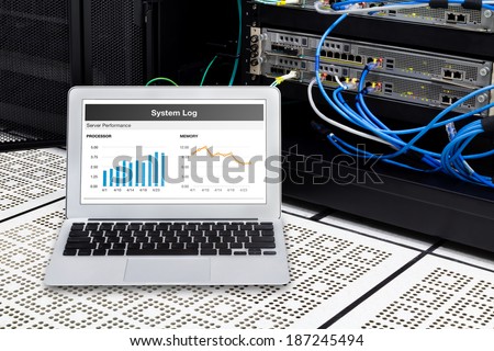 Laptop in network data center, server room. Using for monitoring server computer performance.