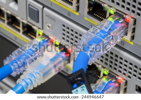 Closeup network cables connected to switches server computer.