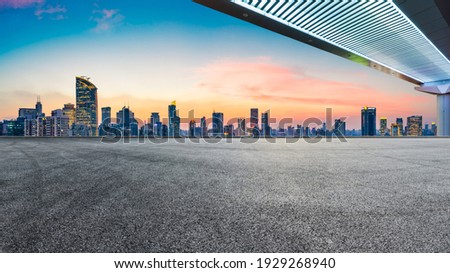 Race track road and bridge with city skyline at night in Shanghai.