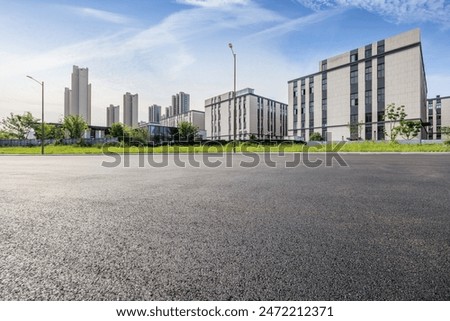 Similar – Image, Stock Photo Empty parking lot. A sign ‘Lehrerparkplatz’ in front of a school building with closed shutters