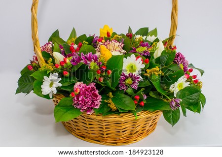 basket with pink chrysanthemum, pink gerberas, yellow tulips, carnations, solidago