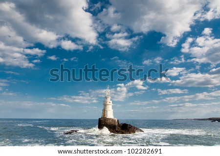Lighthouse in stormy waves