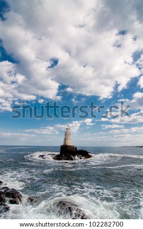 Lighthouse in stormy waves