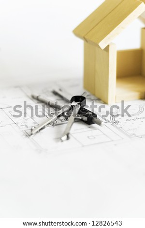 blueprint and wooden model of house
