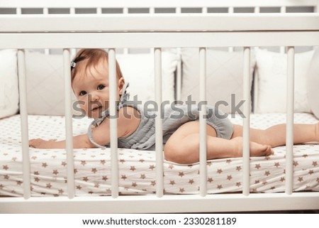 Similar – Image, Stock Photo 6 month old baby playing wearing black and white playing with colorful ring stack toy