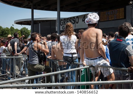 MILAN, ITALY - JUNE 3: Thousands of fans at Springsteen world tour in Milan JUNE 3, 2013. Thousands of fans gather outside the stadium waiting for the gates to open at Bruce Springsteen world tour.