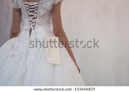 MILAN, ITALY - JUNE 21: Detail of a beautiful white wedding dress at SposaItalia, international exhibition of bridal and formal wear according to Italian style, on JUNE 21, 2013 in Milan
