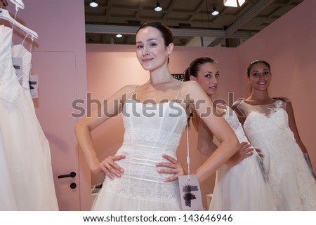 MILAN, ITALY - JUNE 21:  Models with wedding dresses pose at SposaItalia, international exhibition of bridal and formal wear according to Italian style, on JUNE 21, 2013 in Milan