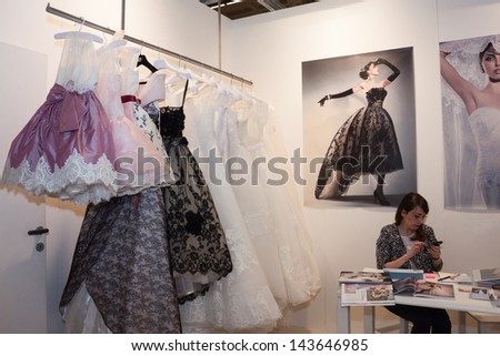 MILAN, ITALY - JUNE 21:  Elegant formal dresses hung up in a stand at SposaItalia, international exhibition of bridal and formal wear according to Italian style, on JUNE 21, 2013 in Milan