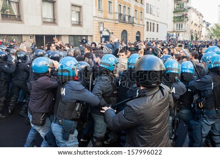 MILAN, ITALY - OCTOBER 11: Secondary school students clash with police while protesting against money cuts in the public school on OCTOBER 11, 2013 in Milan.